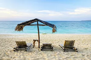 Beach chairs and shade umbrella on Puka Shell Beach, Boracay Island, Aklan Province
