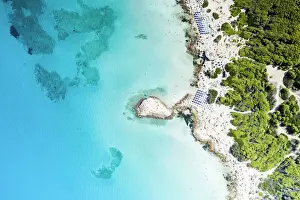 Tropical Climate Prints: Beach umbrellas on sand beach and cliffs by turquoise sea from above, Punta della Suina