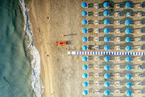 Gargano Prints: Beach umbrellas on sand washed by waves of turquoise sea from above, Vieste
