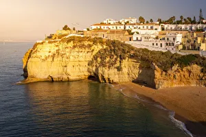 Images Dated 10th January 2019: The beach and village of Carvoeiro at sunrise. Lagoa, Algarve, Portugal