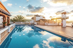 Swimming Pool Prints: Beautiful hotel terrace in Cala Fornells at sunrise, Mallorca, Balearic Islands, Spain