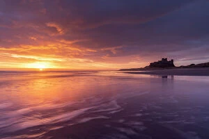 Images Dated 12th June 2023: Beautiful sunrise above Bamburgh Castle on the Northumberland coast, England. Spring (March) 2023