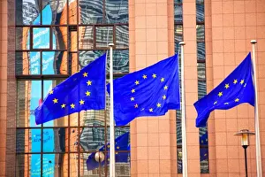 Belgium, Wallonia, Brussels; Three flags carrying the European Union emblem in front of the E
