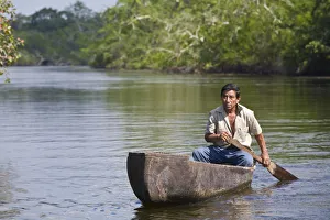Lamanai Prints: Belize, Lamanai, New River, Fisherman in dug out canoe