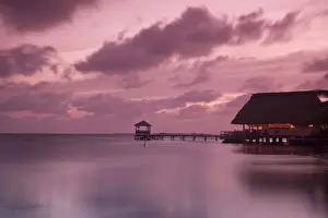 Belize, Placencia, People in beach bar near the Moorings at sunset