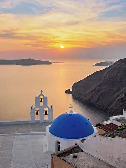 Three Bells of Fira, iconic blue domed church at sunset, Fira, Santorini or Thira Island, Cyclades, Greece