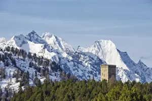 Maloja Prints: The Belvedere Tower frames the snowy peaks and Peak Badile on a spring day Maloja
