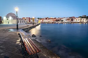 Bench by the sea nearby the old mosque of Chania at dusk, Crete island, Greece