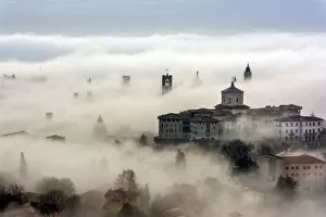 Bergamo, Lombardy, Italy. Foggy sunrise over high city