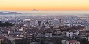 Upper Town Prints: Bergamo, Lombardy, Italy. High angle view over Upper Town (Citta Alta) at sunrise