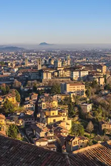 Upper Town Prints: Bergamo, Lombardy, Italy. High angle view over Upper Town (Citta Alta) at sunset