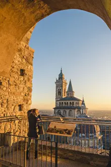 Upper Town Prints: Bergamo, Lombardy, Italy. Tourist photographing the Saint Mary Major (Santa Maria