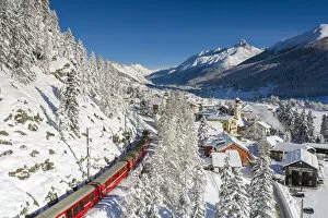 Images Dated 24th March 2021: Bernina Express passes in Madulain, Graubunden, Maloja, Switzerland, Europe