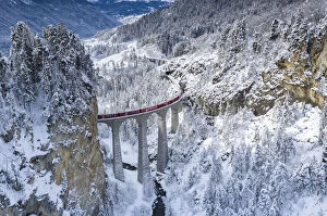 Images Dated 24th March 2021: Bernina Express train on Landwasser viaduct in a snowy winter, Filisur