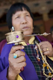 Images Dated 2nd February 2010: Bhutan. Devout Bhuddist worshippers with prayer wheels at the Gantey Gompa in Bhutan