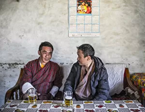 Images Dated 27th May 2020: Two Bhutanese men drinking beer in a local bar, Ura, Bumthang District, Bhutan