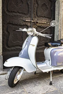 Images Dated 30th August 2018: Bicolored Lambretta Innocenti scooter in front of ancient doorway, Morbegno, Sondrio
