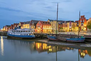 Dwellings Gallery: Binnenhafen port with anchored boats and colorful houses at twilight, Husum, Nordfriesland