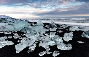 Southeast Iceland Prints: Black volcanic sand beach covered in icebergs from Jokulsarlon glacier lagoon