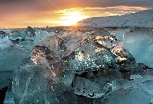Icelandic Prints: Black volcanic sand beach covered in icebergs from Jokulsarlon glacier lagoon at sunset
