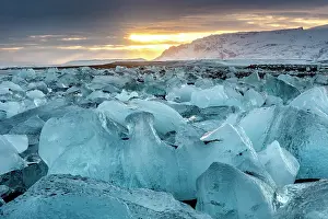 Southeast Iceland Prints: Black volcanic sand beach covered in icebergs from Jokulsarlon glacier lagoon at sunset