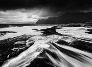 Wave Collection: A black and white perspective of the rugged Okshornan peaks seen from Tungeneset on a stormy evening