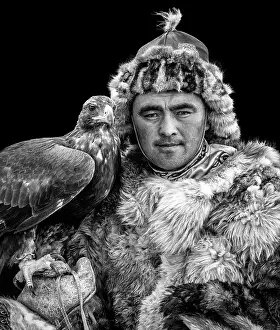Mongolia Prints: Black & white portrait of a Kazakh Eagle Hunter wearing traditional fur clothing