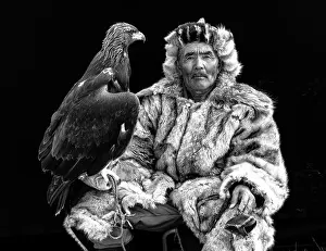 Mongolia Prints: Black & white portrait of a Kazakh Eagle Hunter wearing traditional fur clothing
