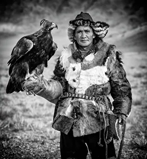 Mongolia Prints: Black & white portrait of a Kazakh Eagle Hunter wearing traditional fur clothing