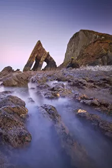 Blackchurch Rock and rocky ledges at twilight, Mouthmill Beach, North Devon, England