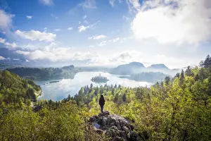 Walker Prints: Bled Lake, Slovenia. Sunrise over the misty island from a high viewpoint with hiker