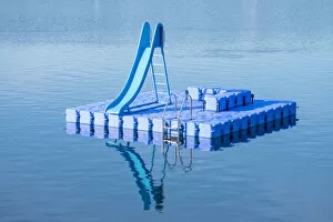 Images Dated 9th May 2019: Blue dock with water slide floating in blue lake, Hamburg Stadtpark, Hamburg, Germany