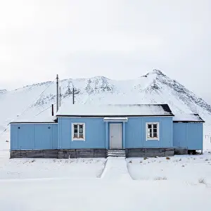 Remote Prints: Blue timber building in remote former mining town of Ny Alesund