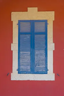 Closed Prints: Blue wooden shutters and red wall in Larnaca, Cyprus