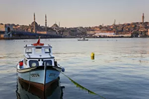 Boat on The Bosphorus, mosque on skyline, Istanbul, Turkey