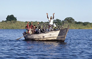 Bicycles Prints: A boat ferries people across the Shire River