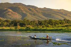 Women Prints: Boat with people going on Inle Lake seen from Maing Thauk bridge (AKA Maing Thouk)