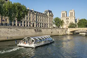 Notre Dame Prints: Boat tour along the banks of the Seine with cathedral Notre Dame in the background