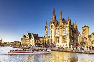Images Dated 25th November 2019: A boat with tourists on the canal with the Ghent town buildings reflecting at sunset
