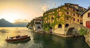 Tourists Gallery: A boat of tourists stops to observe the sunset. Nesso, Province of Como, Como Lake