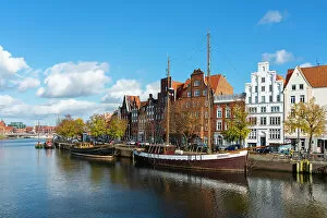 Images Dated 3rd January 2023: Boats anchored on Trave river and houses with traditional gables in background, Lubeck, UNESCO