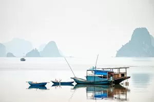 Boats in Bai Tu Long Bay on a foggy day, Cai Rong, Quang Ninh Province, Vietnam