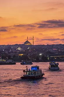 Turkish Gallery: Boats in the Golden Horn at sunset with a Mosque in the background. Istanbul, Turkey