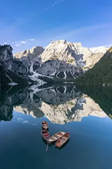 boats in lake Braies (Pragser Wildsee) and Croda del Becco reflected in water, Dolomites