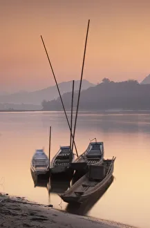 Laos Gallery: Boats on Mekong River at sunset, Luang Prabang, Laos