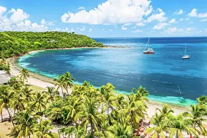 Leeward Islands Prints: Boats moored in a tropical lagoon near the palm fringed Galleon beach