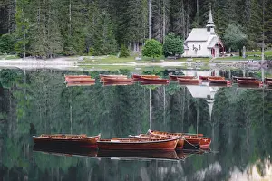 Transparent Prints: Boats in the pristine lake Braies (Pragser Wildsee) with the small chapel mirrored in