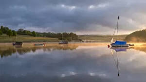Images Dated 20th July 2017: Boats on a reflective Wimbleball Reservoir at sunrise, Exmoor National Park, Somerset