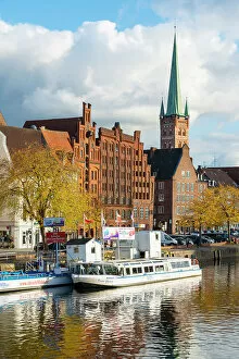 Gable Gallery: Boats on Trave river, traditional houses and St Petri Lubeck Church in background, Lubeck, UNESCO