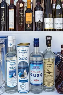 South Aegean Prints: Bottles of traditional Ouzo liquor and local Greek wines on sale in a shop of Oia